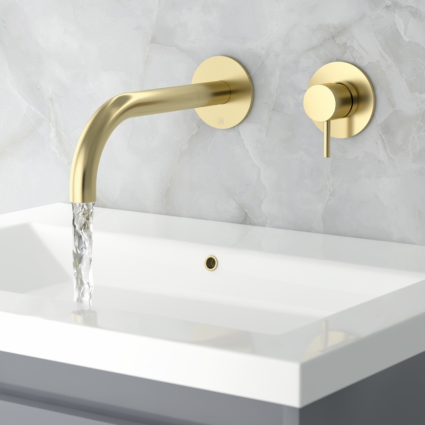 Close up product lifestyle image of the JTP Vos Brushed Brass Wall Mounted Basin Mixer